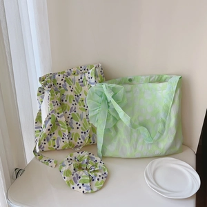 Detail of floral cotton tote and light green bow shoulder bag with matching hair scrunchie
