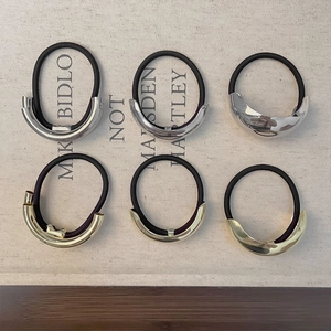 Set of six gold and silver geometric metal hair ties with elastic black ropes