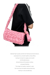 Detail of pink hand-woven cowhide leather shoulder bag with knotted strap and tassel design