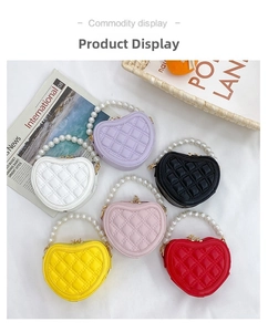 Detail shot of heart-shaped mini bags in multiple colors with pearl handles and quilting