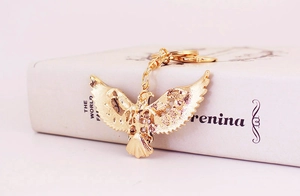 Detailed view of a golden eagle keychain with intricate cutout patterns on its wings