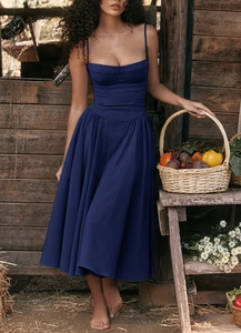Elegant navy blue French vintage strap dress set against a rustic countryside backdrop