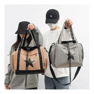 Detail of khaki and grey nylon cross-body bags with star logo and drawstring design