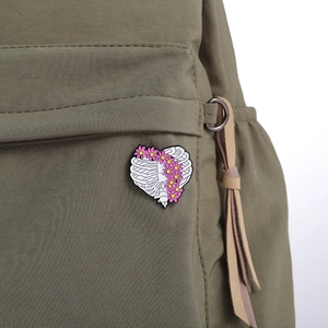 Gothic floral anatomical heart ribcage enamel brooch on olive green canvas backpack