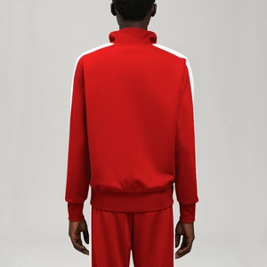 Rear view of red tracksuit with white side stripes and stand-up collar detail
