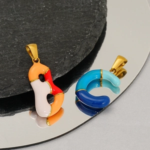 Close-up of multicolored enamel B and C letter pendants with gold metal frames