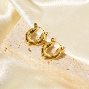 Vintage irregular golden hoop earrings with wavy design on white stone and champagne silk
