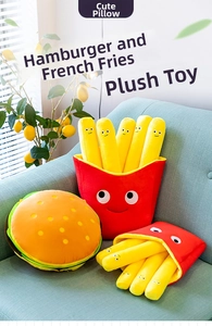 Close-up of plush hamburger and french fries cushions with cute cartoon faces on a sofa