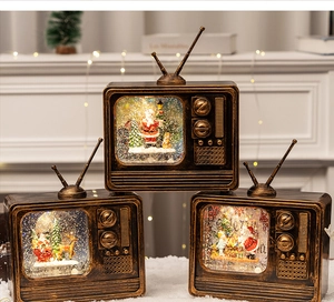 Vintage Christmas TV music box with glowing snow globe and festive miniature scenes