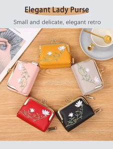 Flat lay of litchi pattern mini purses with flower embroidery and metal clasps