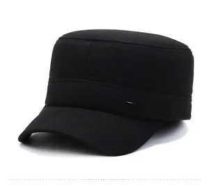 Detail view of the black wool flat top cap featuring a silver Classic metal logo plaque