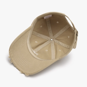 Inside view of khaki vintage distressed cotton baseball cap showing 100% cotton label