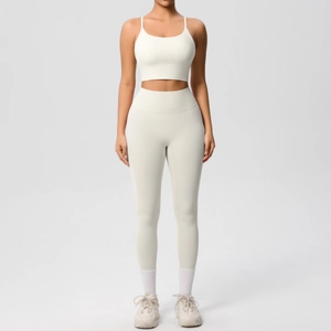 Front view of seamless cream yoga set featuring thin strap sports bra and high waist leggings