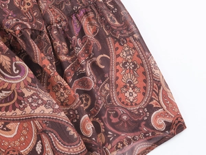 Detailed close-up of lightweight chiffon fabric with vintage paisley print pattern