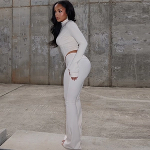 Slim fit two-piece white set with zip-up long sleeve crop top and flared high-waist pants