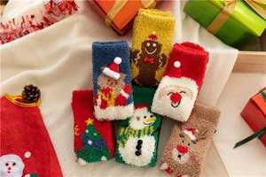 Close-up of thick coral fleece Christmas socks with festive embroidery and 3D patterns