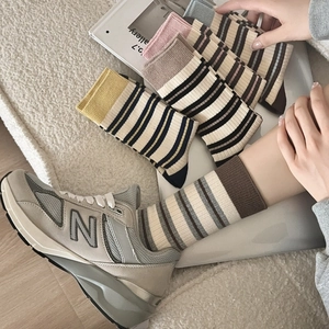 Close-up of cotton crew socks with vintage striped patterns in multiple colors