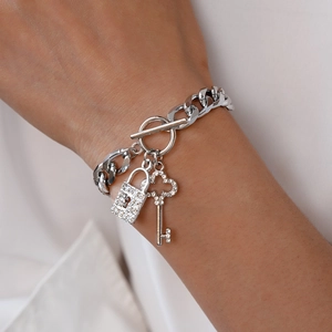 Detail of silver OT buckle bracelet with sparkling rhinestone key and lock charms