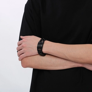 Close-up of a masculine black stainless steel 24mm Cuban link bracelet on a male wrist