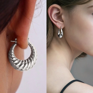 Textured hollow hoop earrings in silver stainless steel shown on model