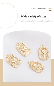 Macro view of 14K gold butterfly and rose embossed rectangle and oval pendants