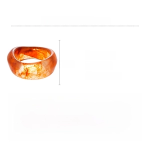Macro detail of amber acrylic wave ring showing dimensions 7.1cm x 3.6cm and smoke texture