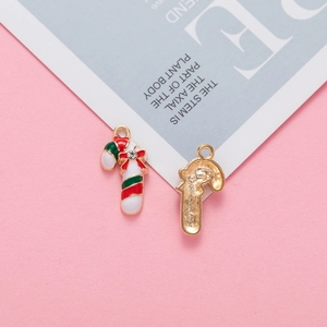 Detail of Christmas candy cane alloy pendant with red enamel finish and rhinestone bow