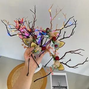 Close-up of LED reindeer antler headband with silk flowers and plush ears detail