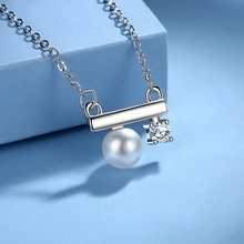 Detail of S925 sterling silver MOM necklace with a white pearl and zircon pendant