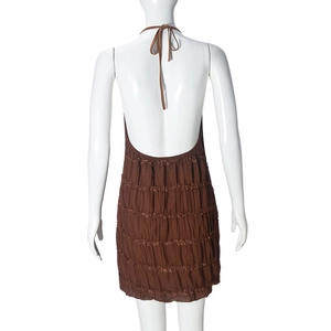 Rear view of a brown halter backless mini dress featuring tiered ruched fabric details