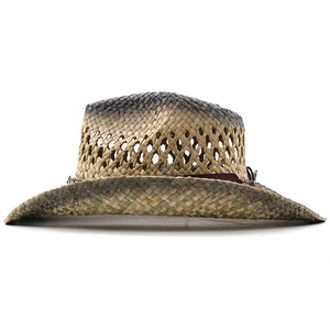Détail d'un chapeau de cowboy en paille dégradée avec design ajouré et bande en cuir