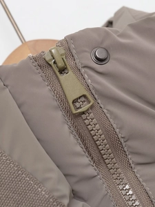 Detailed macro view of the coffee brown jacket featuring metal zipper and reinforced buttons