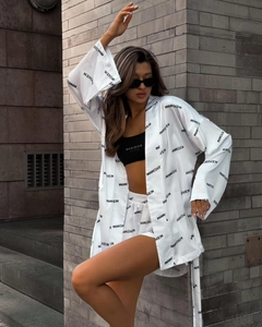 Detailed view of white floral print long sleeve shirt and high waist shorts fashion set
