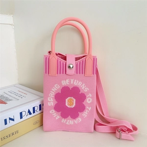 Pink knitted crossbody bag detail with flower pattern and Spring Returns lettering