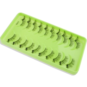 Close-up of natural thick black false eyelashes in a green tray with YK310 model label