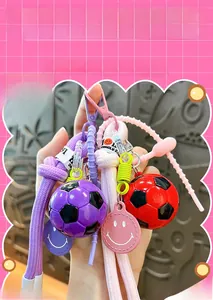 Close-up of colorful acrylic football smiley face keychains with woven lanyards