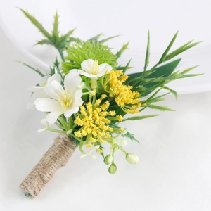 Forest style artificial boutonniere with white flowers and greenery for outdoor weddings