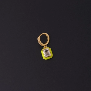 Macro shot of a gold-plated earring featuring bright yellow enamel and a clear zircon stone
