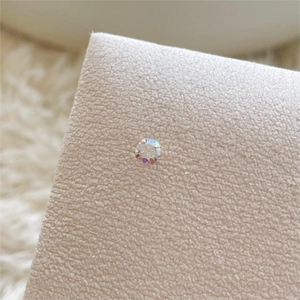 Macro shot of 925 sterling silver four-prong stud earring with rainbow AB crystal