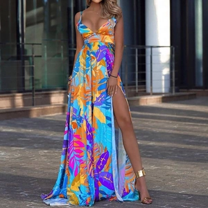Tropical leaf print maxi dress with spaghetti straps and high side slit on urban street