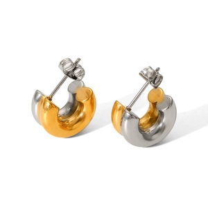 Detail of 18K gold and silver two-tone C-shape stainless steel earrings with butterfly back