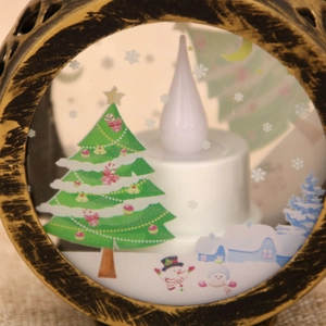 Close-up of vintage bronze Christmas lantern with LED candle and festive snowman scene