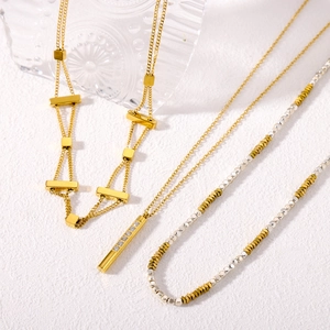 Minimalist gold and silver layered chains with geometric pendants and rhinestone details