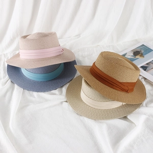 Straw boater sun hats for women in various colors with elegant decorative ribbons
