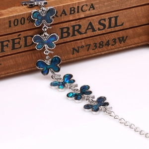 Detail of silver butterfly bracelet with colorful abalone shell inlays and extension chain