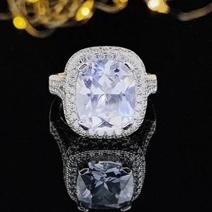 Macro view of luxury silver ring with large square main diamond and halo accent stones