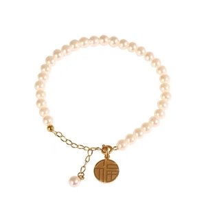 18K gold plated pearl bracelet with a round fortune charm on a white background