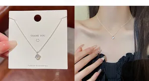 Detail of titanium steel necklace with zircon bow pendant and silver polished finish