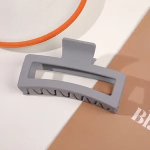 Detail of matte grey rectangular claw clip showing smooth finish and strong grip teeth
