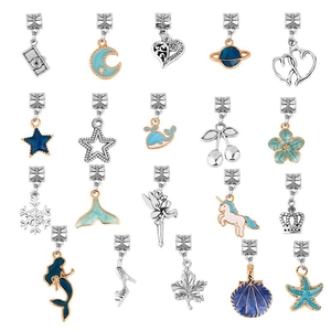 Macro shot of 20 diverse gold enamel charms including unicorn, star, and heart shapes
